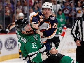 Colorado Avalanche defenseman Jacob MacDonald and Dallas Stars center Luke Glendening fight in the third period at Ball Arena.