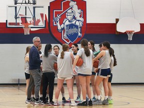 Sean Culhane, head coach of the Holy Names Knights senior girls' basketball team, talks to his players at practice ahead of the OFSAA girls' AAA championship on Thursday.