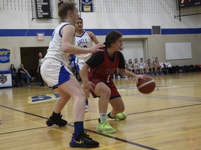 Holy Names Knights' guard Yasmine Kadri looks for help as two Hamilton Cathedral players close in during Saturday's gold-medal game at the OFSAA girls' AAA basketball championship at St. Anne high school. (Photo by Kathleen Saylors/Windsor Star)