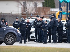 Windsor police officers confer in the Devonshire Heights are on Nov. 30, 2022.