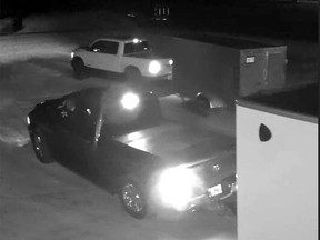 Surveillance camera images of two pick-up trucks and trailers believed to be involved in a major break-and-enter crime in the Lakeshore area on Nov. 23, 2022.