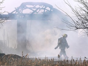A Lakeshore firefighter is shown on the scene of a structure fire at a home on County Road 42 between West Belle River Road and Rourke Line Road on Thursday, Nov. 10, 2022. The large garage-type structure fire resulted in County Road 42 being shut down for several hours. No injuries were reported.