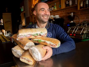 Giovanni cassano, owner of ortona in walkerville, holds half a dozen cold cut sandwiches, as his restaurant is participating in the 2022 meals for mental health, on saturday, nov. 5, 2022.