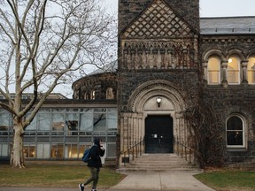 A student walks through the University of Toronto campus in Toronto.