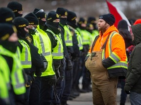 An inquiry into using the Emergencies Act to help end so-called Freedom Convoy blockades heard a Windsor union leader had suggested his members could help end the one that shut down the Ambassador Bridge. In this Feb. 12, 2022, file photo, protesters yell at police as they attempt to clear Huron Church Road.