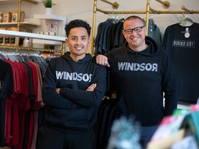 Tam Nguyen (left) and Scott Bisson (right) show WINDSOR logo clothing from their RARE Apparel brand. Photographed at Whiskeyjack Boutique in Windsor on Nov. 23, 2022.