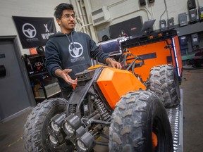 Stephen Vaidyan, a mechanical engineer at Optimotive Technologies, is pictured with an Iris 2 mk1 data collection robot, on Friday, Nov. 18, 2022.