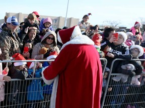 Santa Claus meets with fans after a helicopter lands at Windsor's Devonshire Mall in November 2019.