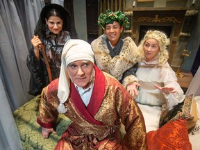 Jim Reid (front) plays Ebenezer Scrooge with (from left) Angela Ibrahim, Jason Andrew, and Kathy Roberts as the Christmas Ghosts in Windsor Light Music Theatre's production of A Christmas Carol, playing Nov. 18-20 and 25-27 at the Chrysler Theatre. Photographed Nov. 17, 2022.