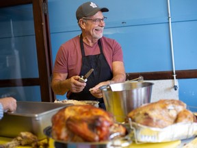 Master carver Larry Morand slices the turkey as volunteers at Cottam United Church prepare for their annual Turkey Dinner, on Thursday, Nov. 24, 2022 — U.S. Thanksgiving Day.