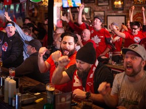 Fans react as they watch Canada take on Belgium for their first game in the World Cup tournament in 36 years, while at the Manchester Pub, on Wednesday, Nov. 23, 2022.