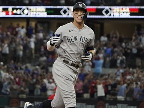 New York Yankees' Aaron Judge gestures as he runs the bases after hitting a solo home run, his 62nd of the season, during the first inning in the second baseball game of a doubleheader against the Texas Rangers in Arlington, Texas, Tuesday, Oct. 4, 2022.