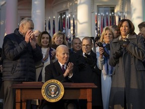 U.S. President Joe Biden applauds after signing the Respect for Marriage Act on the South Lawn of the White House in Washington, D.C., Tuesday, Dec. 13, 2022.