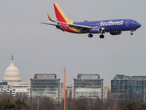 A Southwest Airlines aircraft flies past the U.S. Capitol before landing at Reagan National Airport in Arlington, Va., Jan. 24, 2022.