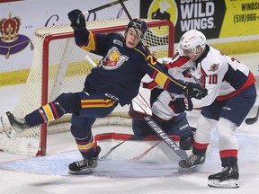 Cole Beaudoin, left, of the Barrie Colts tangles with Windsor Spitfires' defenceman Daniil Sobolev during Saturday's game at the WFCU Centre, which Windsor won 5-2.