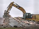 A crane operator demolishes a Banwell Road residential property on Friday, December 9, 2022 that was expropriated by the City of Windsor to make way for the NextStar EV Battery Plant.