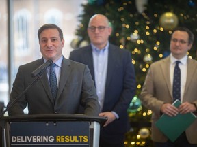 Public Safety Minister, Marco Mendicino, announces a grant of $6.9 million dollars to cover costs associated with the Ambassador Bridge blockade, while Mayor Drew Dilkens and MP Irek Kusmiercyzk look on, at City Hall, on Thursday, Dec. 29, 2022.
