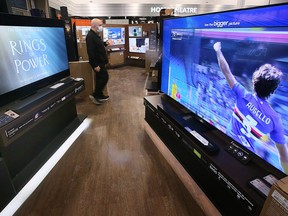 A Boxing Day shopper checks out televisions at the Best Buy store in Windsor on Monday, December 26, 2022.