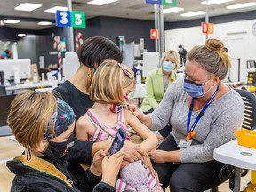 A child is vaccinated in Victoria, B.C., in this November 2021 file photo.
