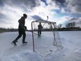 Ahead of a year-end thaw in the local temperatures, Isaac Phillips, left, and Conner Barris play hockey on Blue Heron Pond in east Windsor on Tuesday, Dec. 27, 2022.