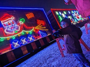 Jack Layfield, 3, from Tecumseh, points at the bright flashing lights on the CP Holiday Train during its stop in Windsor on Thursday, Dec. 1, 2022.