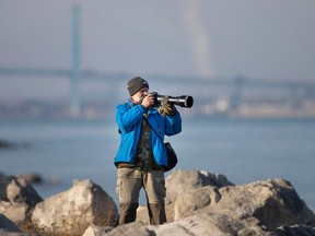 Local photographer Armand Joseph takes advantage of the sun along Windsor's riverfront on Wednesday, Dec. 21, 2022, ahead of a winter storm moving in. Recreation and public access are among the improved beneficial uses of cleaning up Great Lakes hotspots, like the Detroit River "area of concern," under a binational agreement.