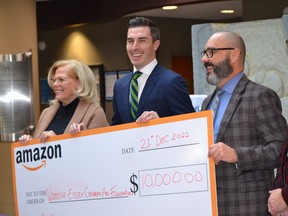 Cheryl Sprague, Windsor-Essex Children's Aid Society Foundation board of directors president, from left, Brooks Barnett, Amazon manager of economic development and Derrick Drouillard, WECAS executive director with a $10,000 cheque Wednesday, Dec. 21, 2022, at the Windsor-Essex Children's Aid Society. Amazon Canada also donated boxes of household and other goods for children and families at WECAS.