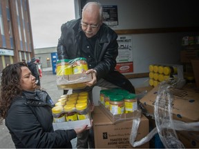 Rick Rose from Keller Williams Lifestyles Realty Brokerage drops off a truckload of donated food items to the Downtown Mission as executive director Rukshini Ponniah-Goulin helps with the unloading, on Tuesday, Dec. 6, 2022.