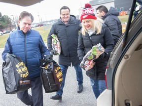 From left: City of Windsor Ward 8 County. Windsor-Tecumseh MP Gary Kaschak, Irek Kusmiercyzk and June Muir, CEO of the UHC Hub of Opportunities, help distribute 500 food baskets to those in need on Tuesday, December 20, 2022.