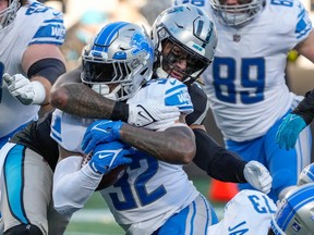 Detroit Lions running back D'Andre Swift is tackled by Carolina Panthers linebacker Frankie Luvu during the second half at Bank of America Stadium.