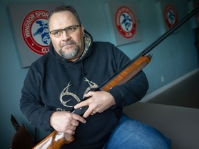 Ray Boilard holds a semi-automatic hunting gun at the Windsor Sportsmen Club where he is a member, on Monday, Dec. 19, 2022.