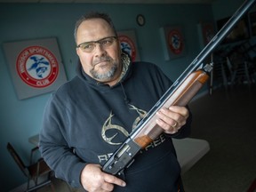 Ray Boilard holds a semi-auto shotgun at the Windsor Athletes' Club, of which he is a member, Monday, December 19, 2022.