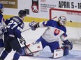 Slovakia goaltender Patrik Andrisik watches as the puck goes into the net as Slovakia's Maxim Strbak and Finland's Oliver Kapanen look on during second period IIHF World Junior Hockey Championship hockey action in Moncton, N.B., on Tuesday, Dec. 27, 2022.