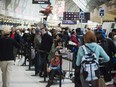 Passengers line-up during flight delays and cancellations due to extreme cold weather and wind chill at Pearson International Airport in Toronto on Tuesday January 7, 2014.