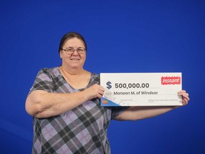 Moneen McIntyre of Windsor holds her prize cheque from playing the scratch game $500 Grand. Photographed December 2022.