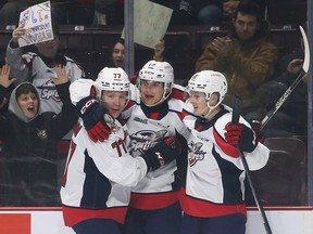 James Jodoin, left, Ethan Miedema and Noah Morneau celebrate Miedema's goal for the Windsor Spitfires on Thursday in a 5-3 win over the Ottawa 67's at the WFCU Centre.