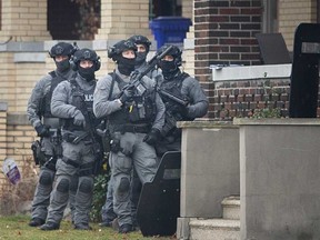 Windsor police officers in tactical gear surround a home in the 900 block of Parent Avenue on Wednesday Dec. 7, 2022.