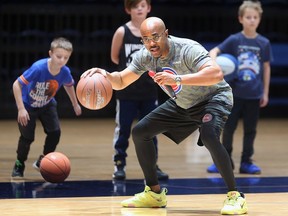 Aaron Smith, director of youth engagement and development with the Detroit Pistons instructs players during a basketball camp on Saturday, December 17, 2022 at the Toldo Lancer Centre.