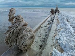 'It's other-worldly.' Strong winds and sprayed lake water have created striking frozen sculptures along the pier at Port Stanley on Lake Erie's north shore. The figure in the foreground, shown Tuesday, Dec. 27, 2022, was formed on a lamp post.