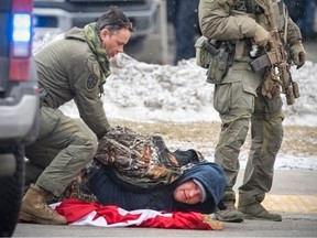 Arrests are made as police push back protesters participating in a blockade of the Ambassador Bridge near Huron Chruch Road and Tecumseh Road West on Sunday, Feb. 13, 2022.