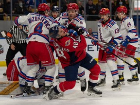 Windsor Spitfires' forward Alex Christopoulos draws a crowd in front of the Kitchener Rangers' net with Matthew Andonovski leading the way during Friday's game at the Memorial Auditorium.