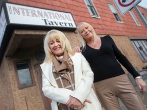 June Muir, president of the Windsor-Essex Food Bank Association, is pictured with the new owner of the International Tavern, Sally Stricko, on Tuesday, Dec. 6, 2022.