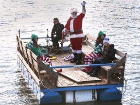 WINDSOR, ON. DECEMBER 3, 2022 -  Santa arrives via pontoon on Saturday, December 3, 2022 during the River Canard Christmas Festival. The event was sponsored by the River Canard Canoe Company.