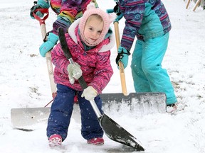 Children shovel snow on a driveway on Brock Street in Windsor in this December 2017 file photo.