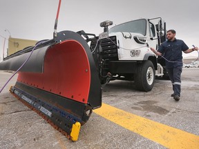 Tim Heinrichs, a mechanic with the City of Windsor does some last minute checks to a snowplow at the Public Works yard on Crawford Avenue on Thursday, December 22, 2022.
