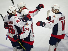 Teammates congratulate rookie Liam Greentree 66), at left, after his 10th goal in of the season on Saturday in the Windsor Spitfires' 5-4 comeback win in overtime over the Kitchener Rangers at the WFCU Centre.