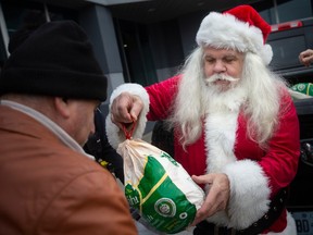 Santa helps the Wyandotte Business Improvement Association hand out 101 fresh turkeys to those in need outside of Al Sabeel Restaurant, on Tuesday, Dec. 13, 2022.
