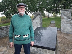 In this Oct. 8, 2021, file photo, author Gene Lotz is shown at the recently vandalized Masonic War Memorial in Malden Park, with the removed plaque in the background.