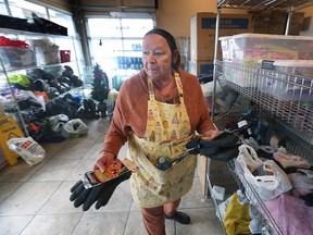 Christine Wilson-Furlonger, administrator at Street Help grabs gloves and hand-warmers to hand out to clients at the organization on Thursday December 22, 2022.
