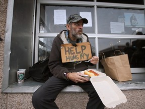 A homeless man grabs a welcome bite to eat at Windsor's Street Help on Friday, Nov. 11, 2022.